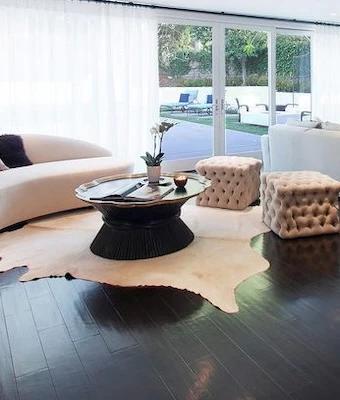 cowhide rug on the floor in living room