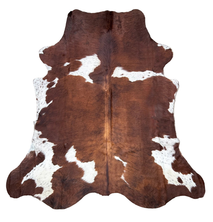 Brown and white cowhide rug