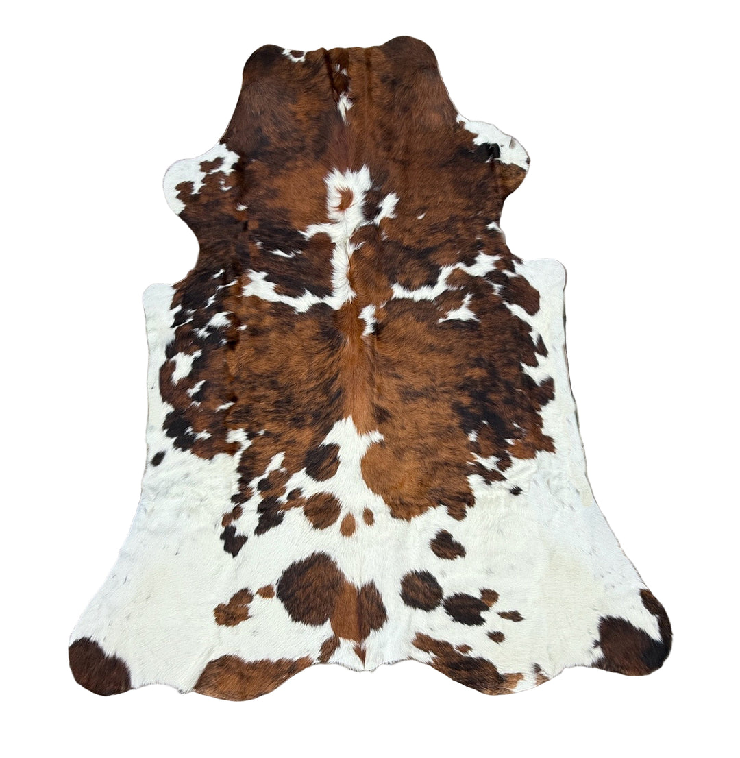 Brown and white cowhide rug