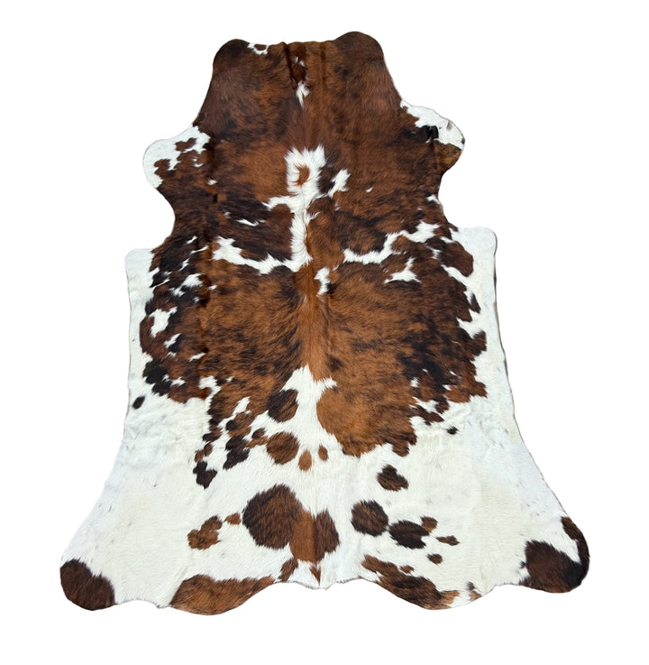 Brown and white cowhide rug