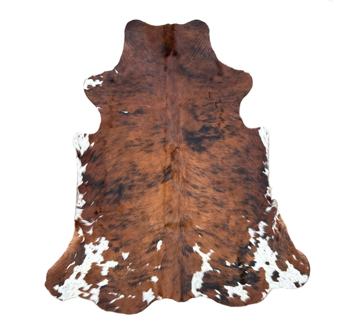 Brown and white cowhide rug