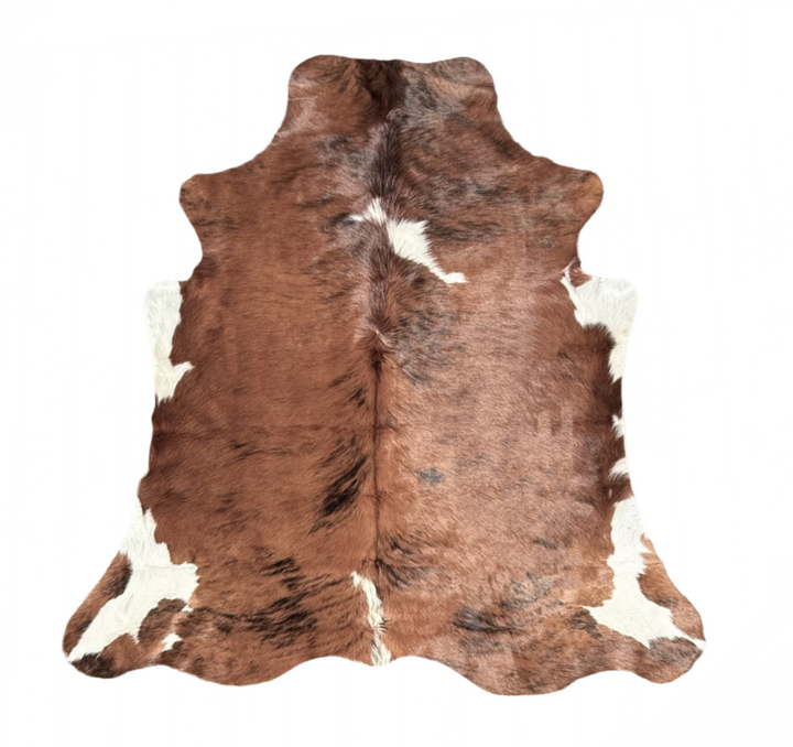 Brown and white cowhide rug