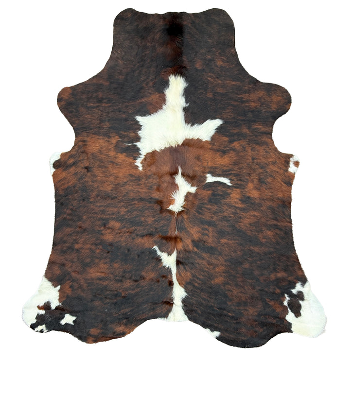 Brown and white cowhide rug