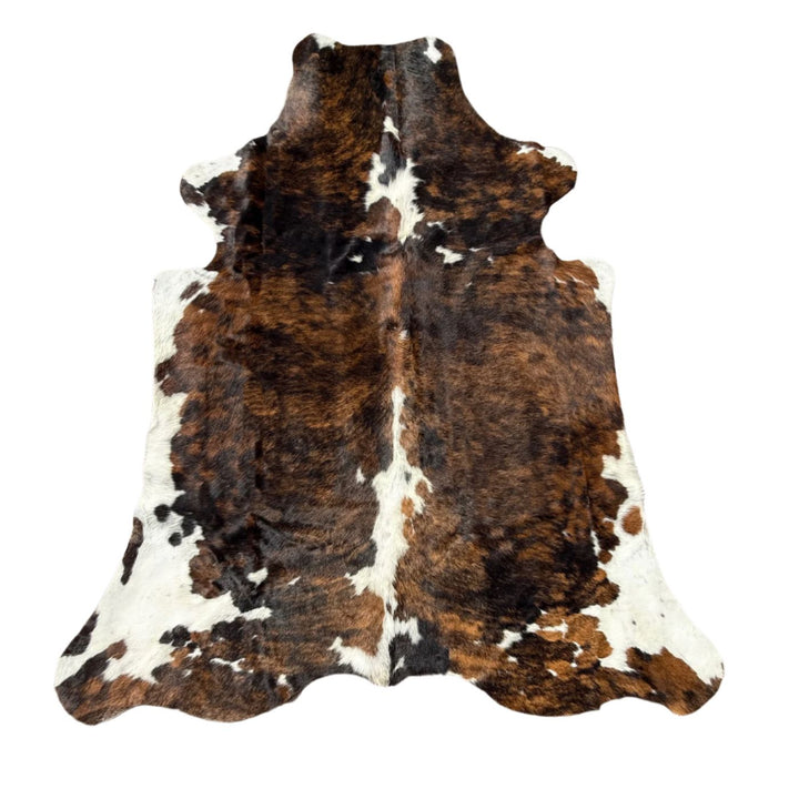 Brown and white cowhide rug
