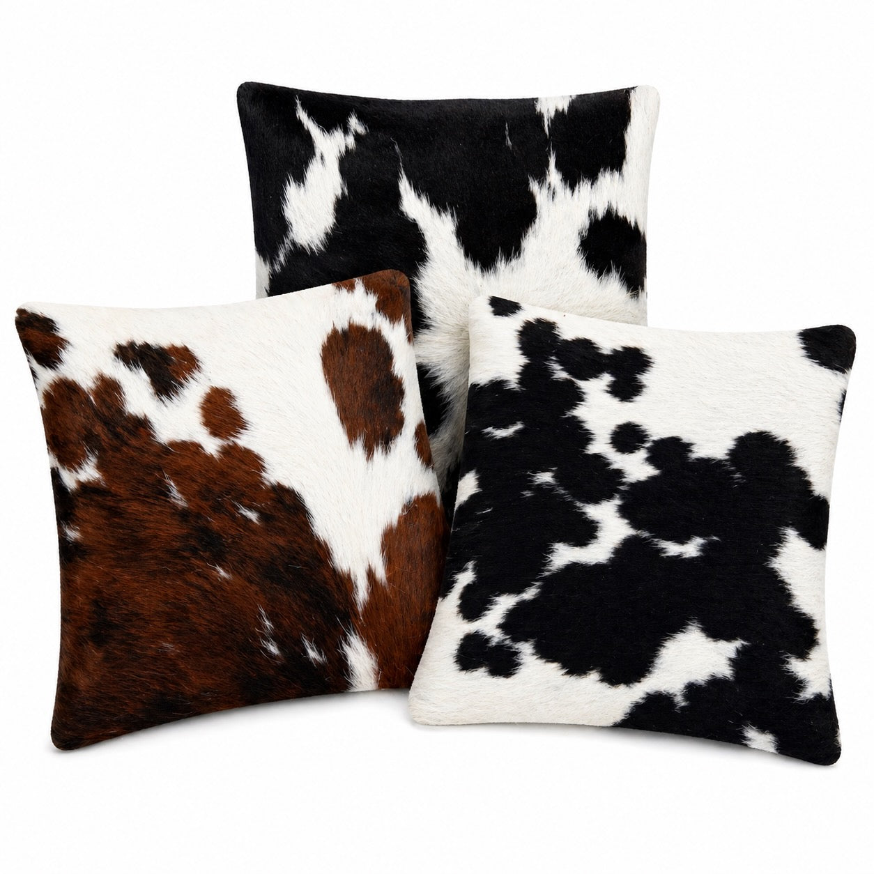 cowhide cushions black and white and one tricolour