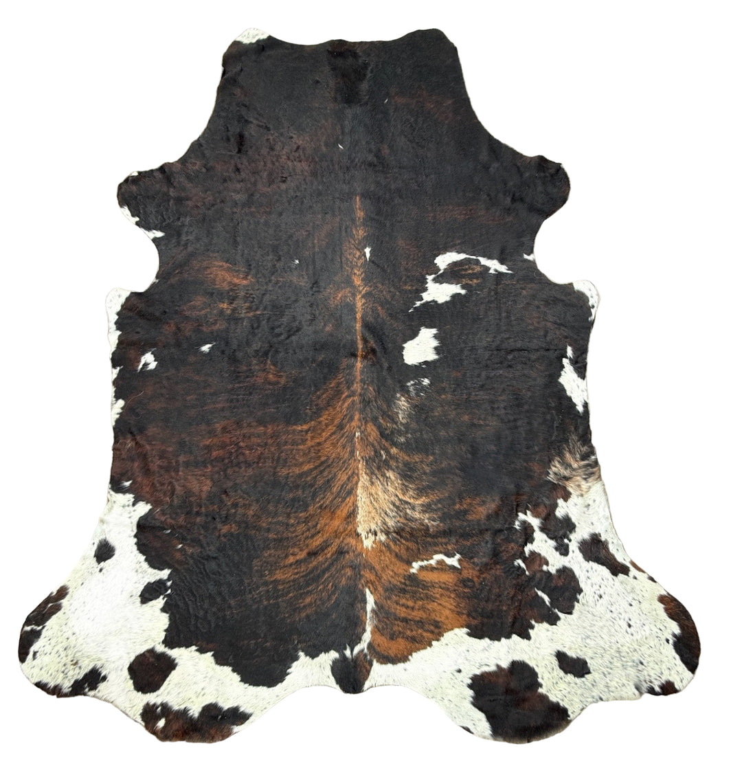 Cowhide rug with black, brown, and white pattern 