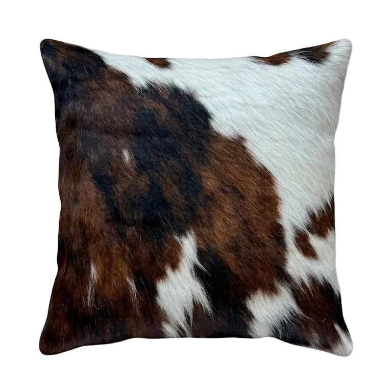A square cushion featuring a brown and white cowhide print.