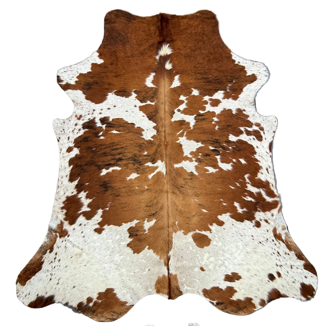 Extra large Brazilian tricolour cowhide rug by Cowhide Rugs London, 225x210cm, featuring natural black, white, and brown patches.