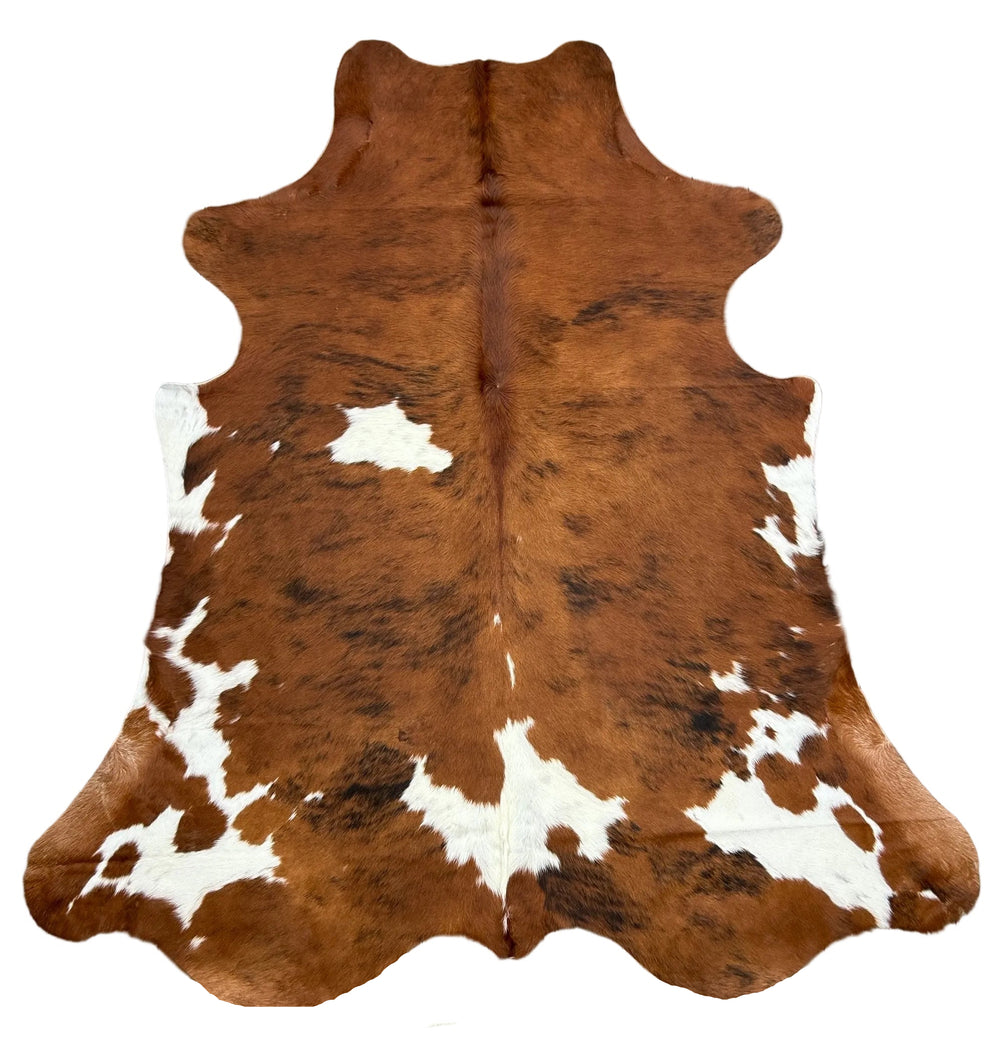 Large Brazilian tricolour cowhide rug from Cowhide Rugs London, featuring natural black, white, and brown patterns, 235x210cm.