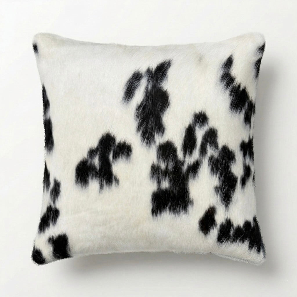 Decorative pillow with black and white cow hide rug cushion