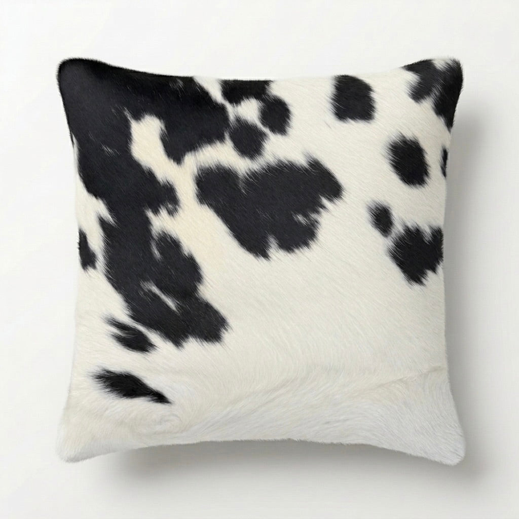 Decorative pillow with black and white cow print pattern 