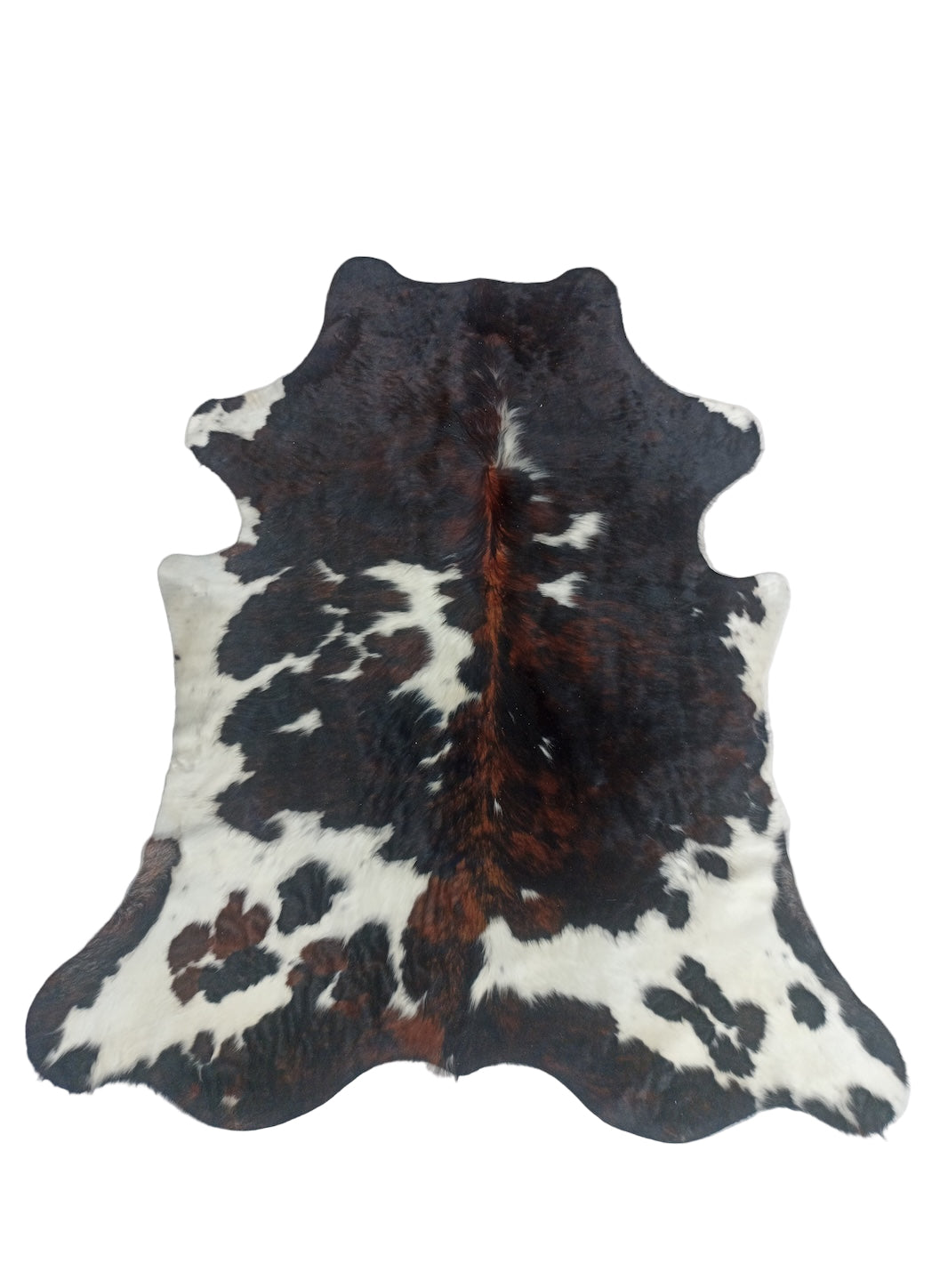 Cowhide rug with black, brown, and white pattern 