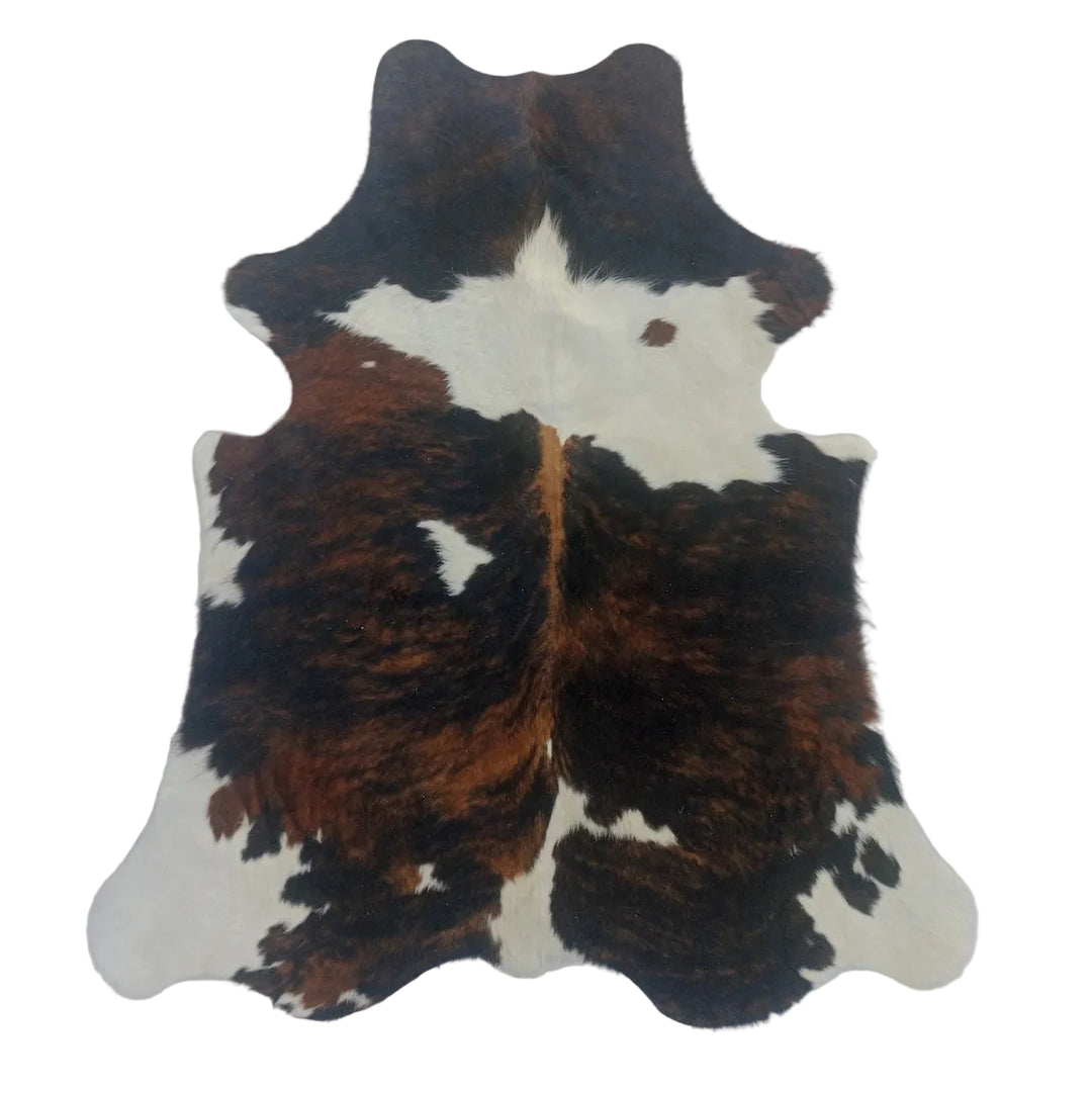 Cowhide rug with black, brown, and white pattern 
