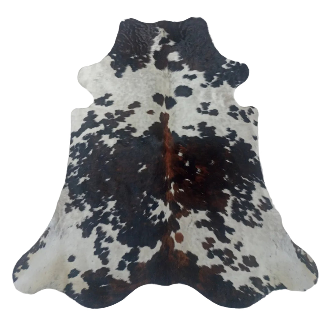 A natural black and white cowhide rug  with some brown