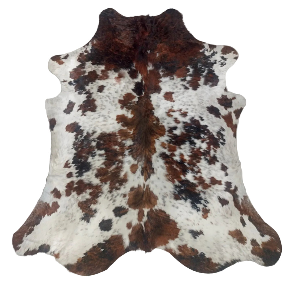 A natural cowhide rug with a brown and black spotted pattern on a white base