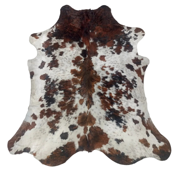 A natural cowhide rug with a brown and black spotted pattern on a white base
