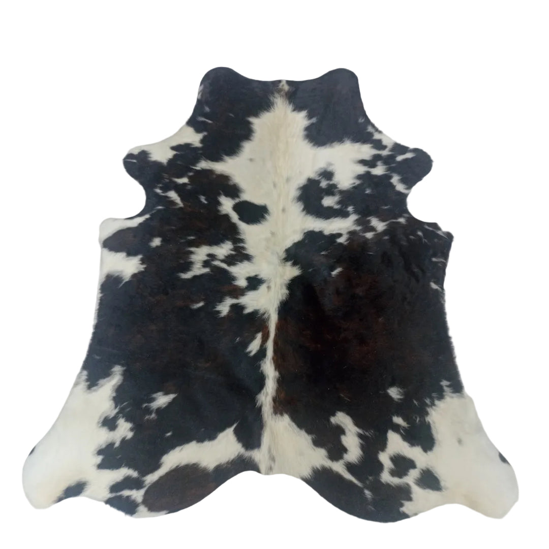 A black and white cowhide rug laid flat 