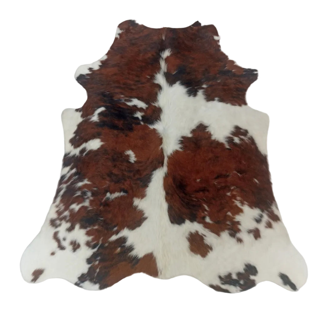 A natural cowhide rug with a brown and white mottled pattern, laid flat on a white surface