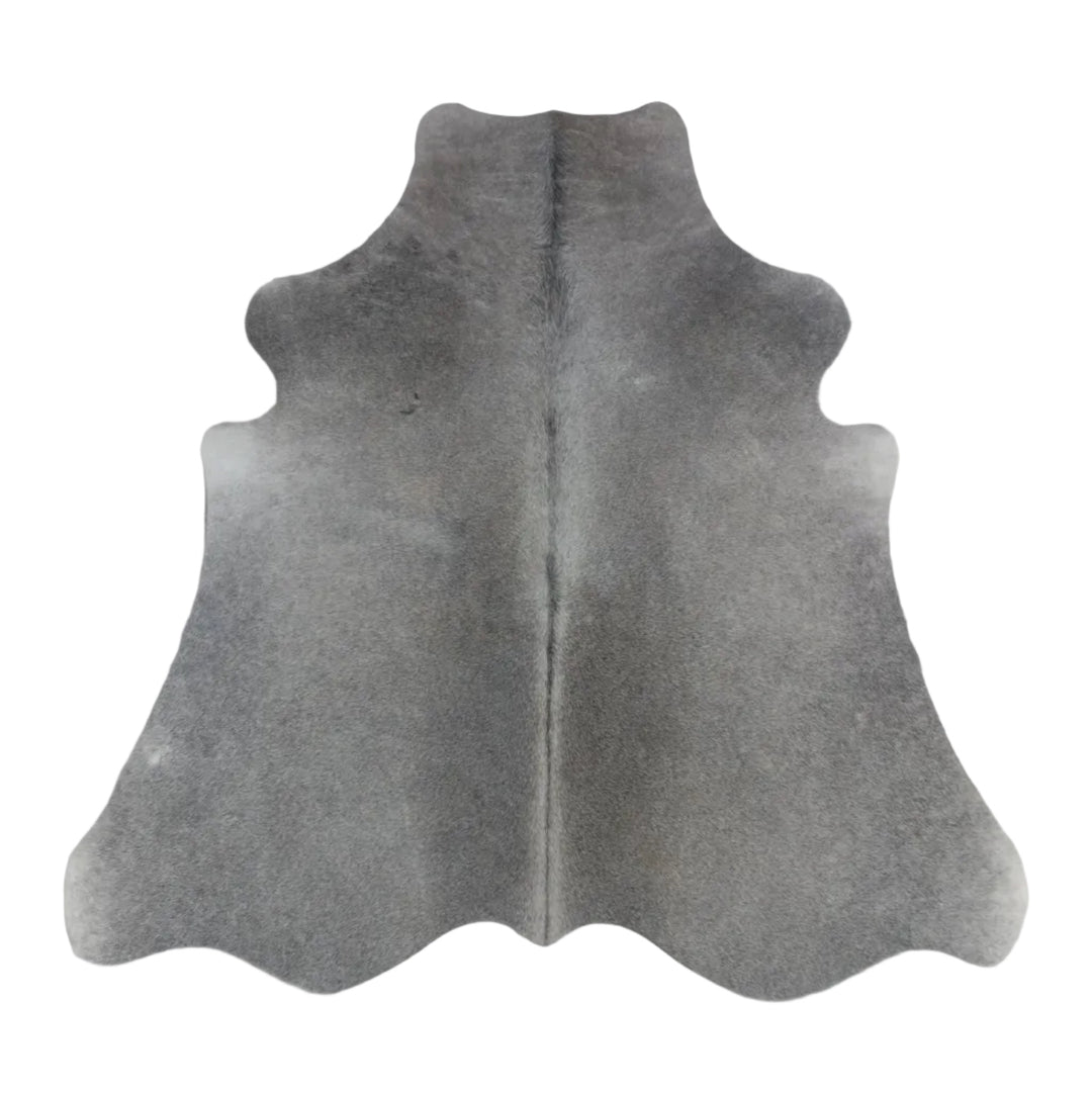 A dark gray cowhide rug with a natural split down the center, laid flat on a light  surface.