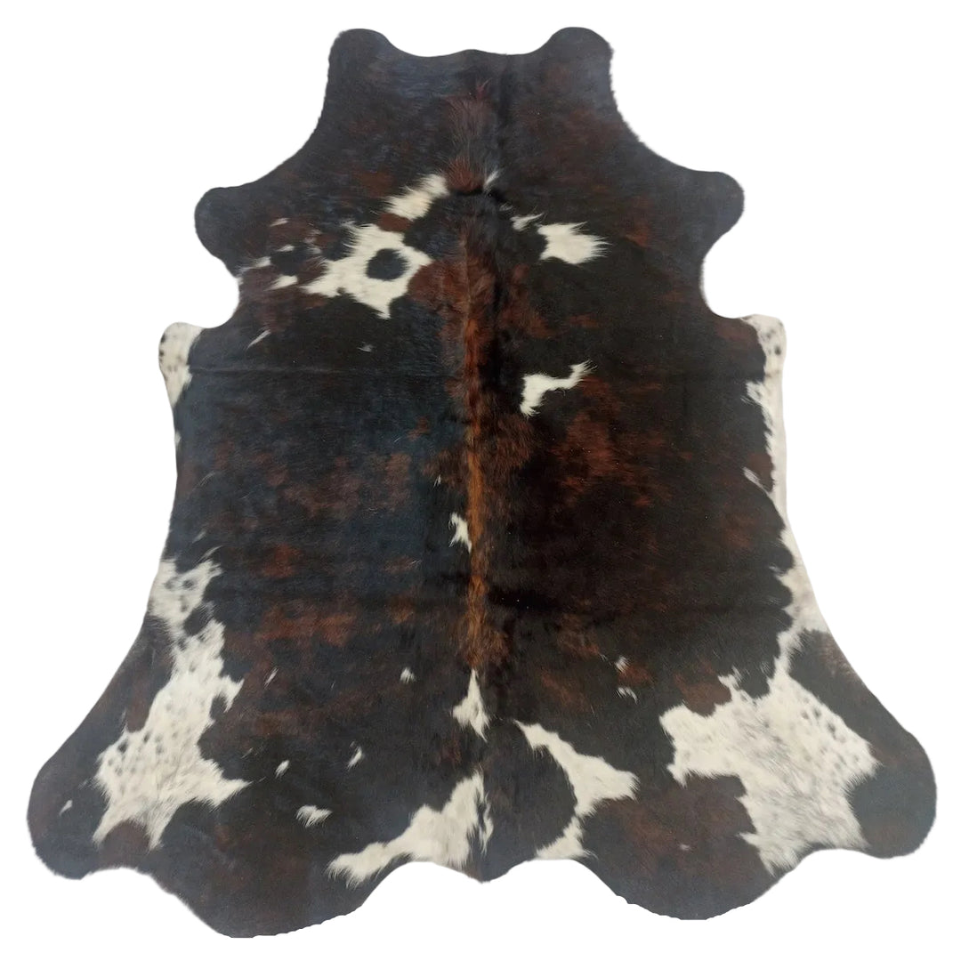 Cowhide rug with black, brown, and white pattern on a white background