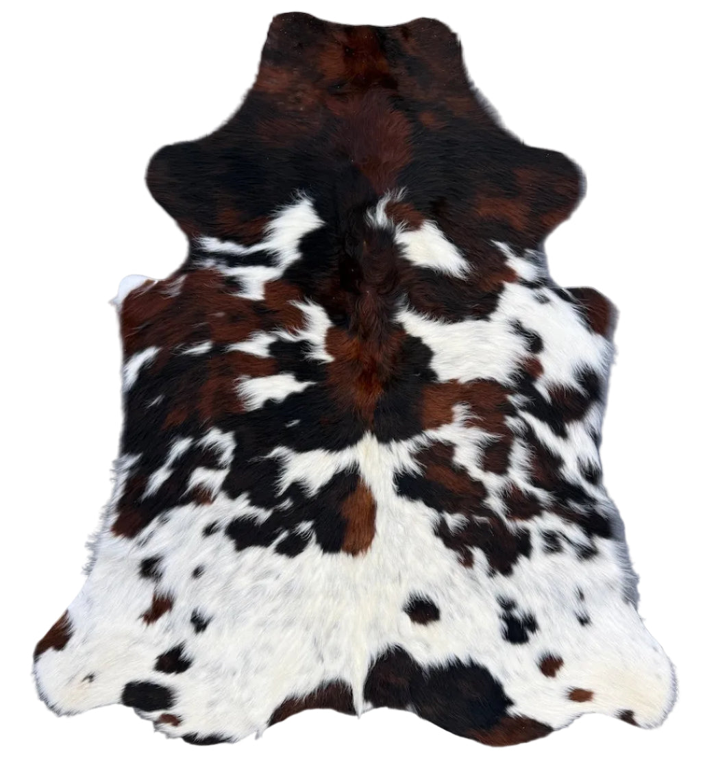 A cowhide rug with a brown and white spotted pattern,