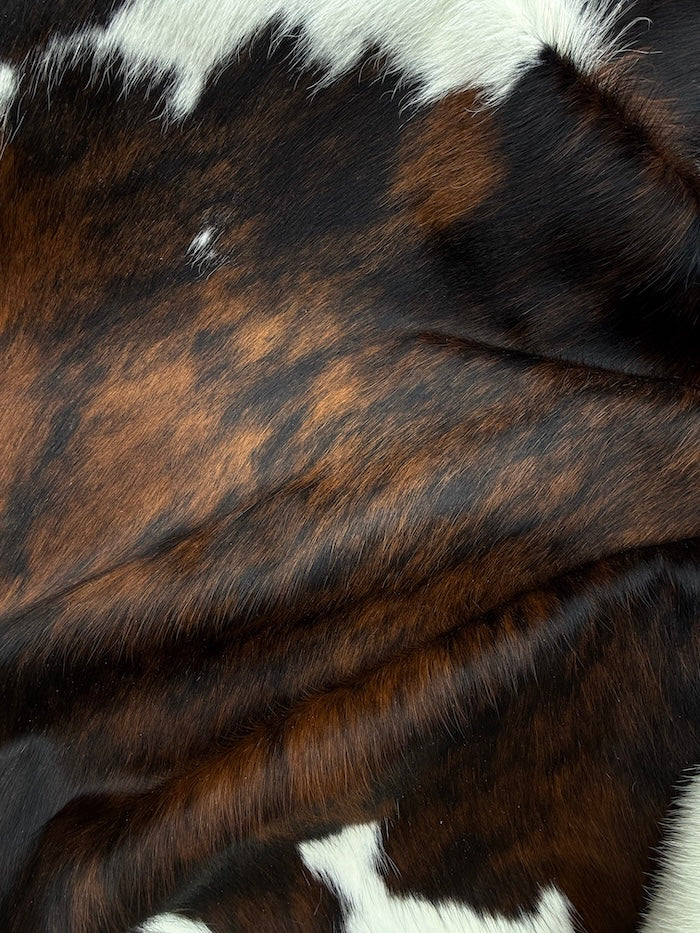 Extra large Brazilian Tricolour Cowhide Rug by Cowhide Rugs London, 232x202cm, showcasing its distinctive tri-color pattern and natural texture.