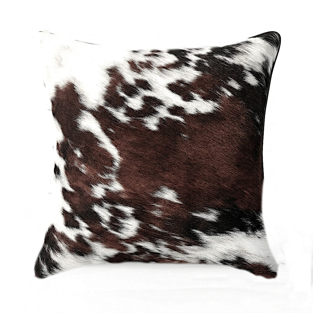 Brown and white cowhide pillow