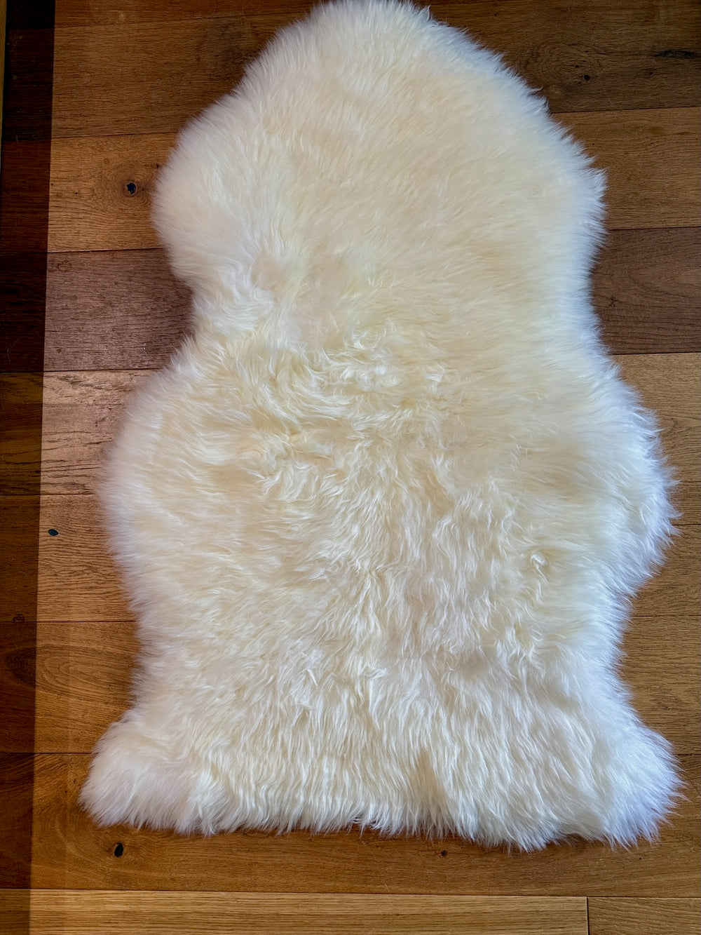 White fur rug on a wooden floor