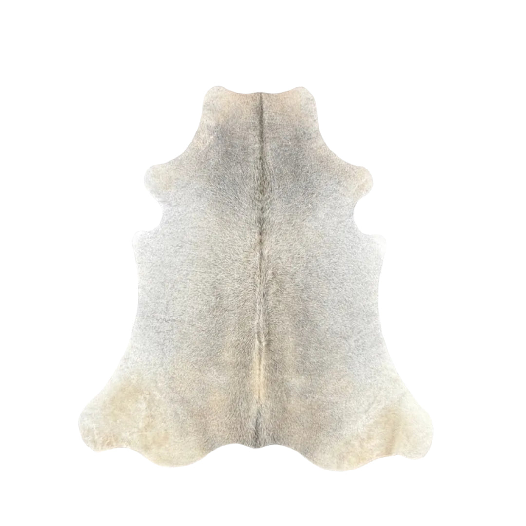 A natural cowhide rug laid flat 