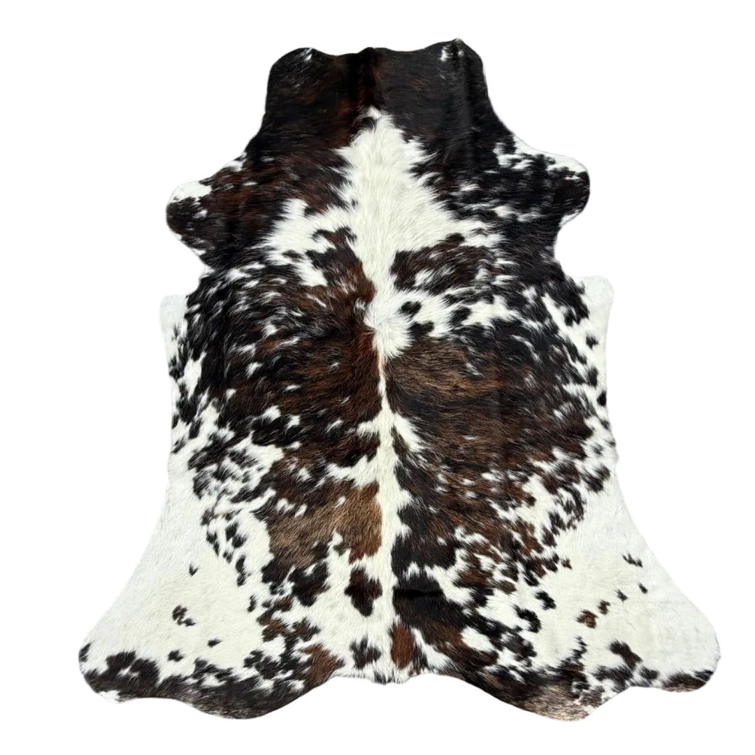 A natural black and white cowhide rug l