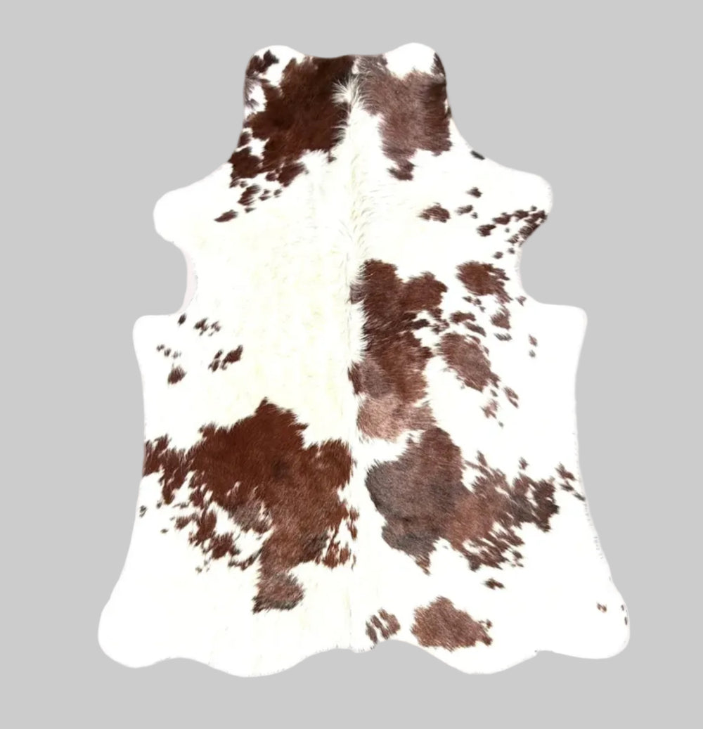 A natural cowhide rug with a brown and white mottled pattern