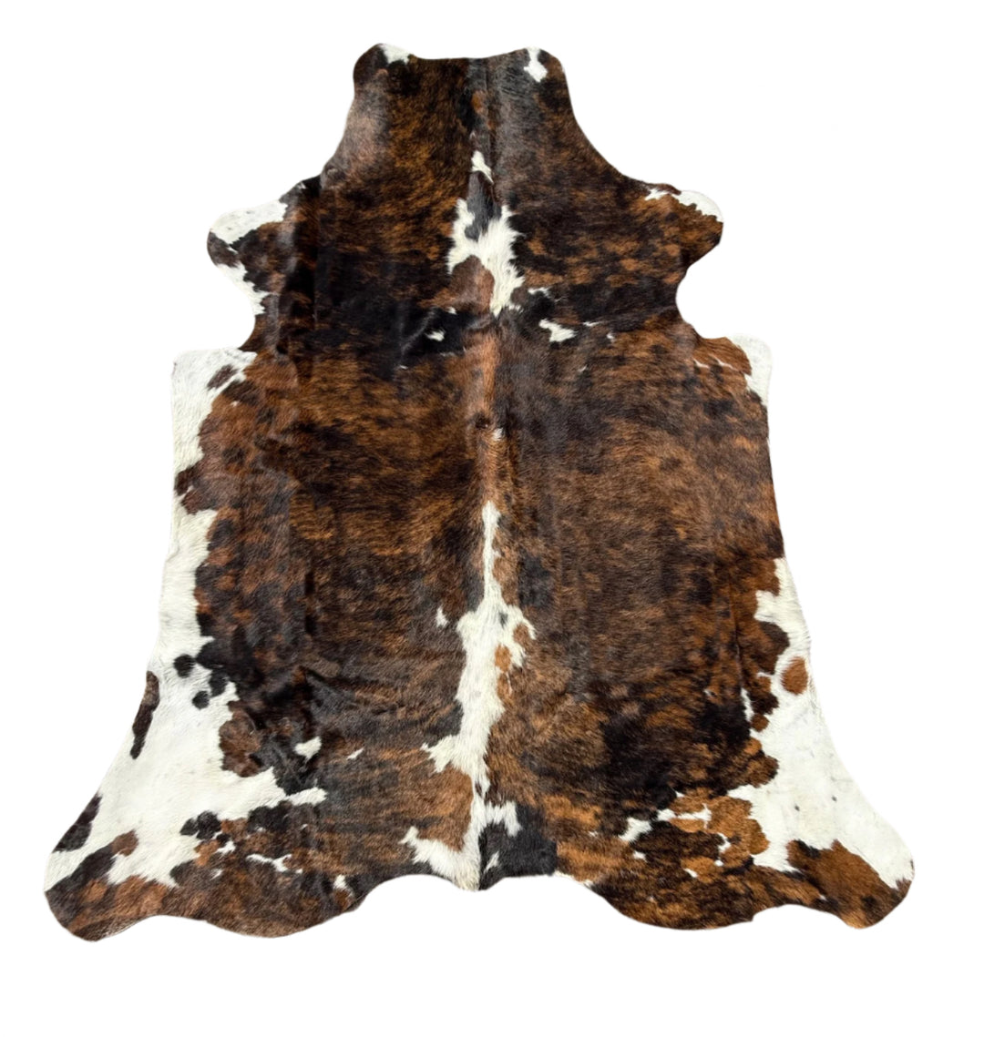 Brown and white cowhide rug