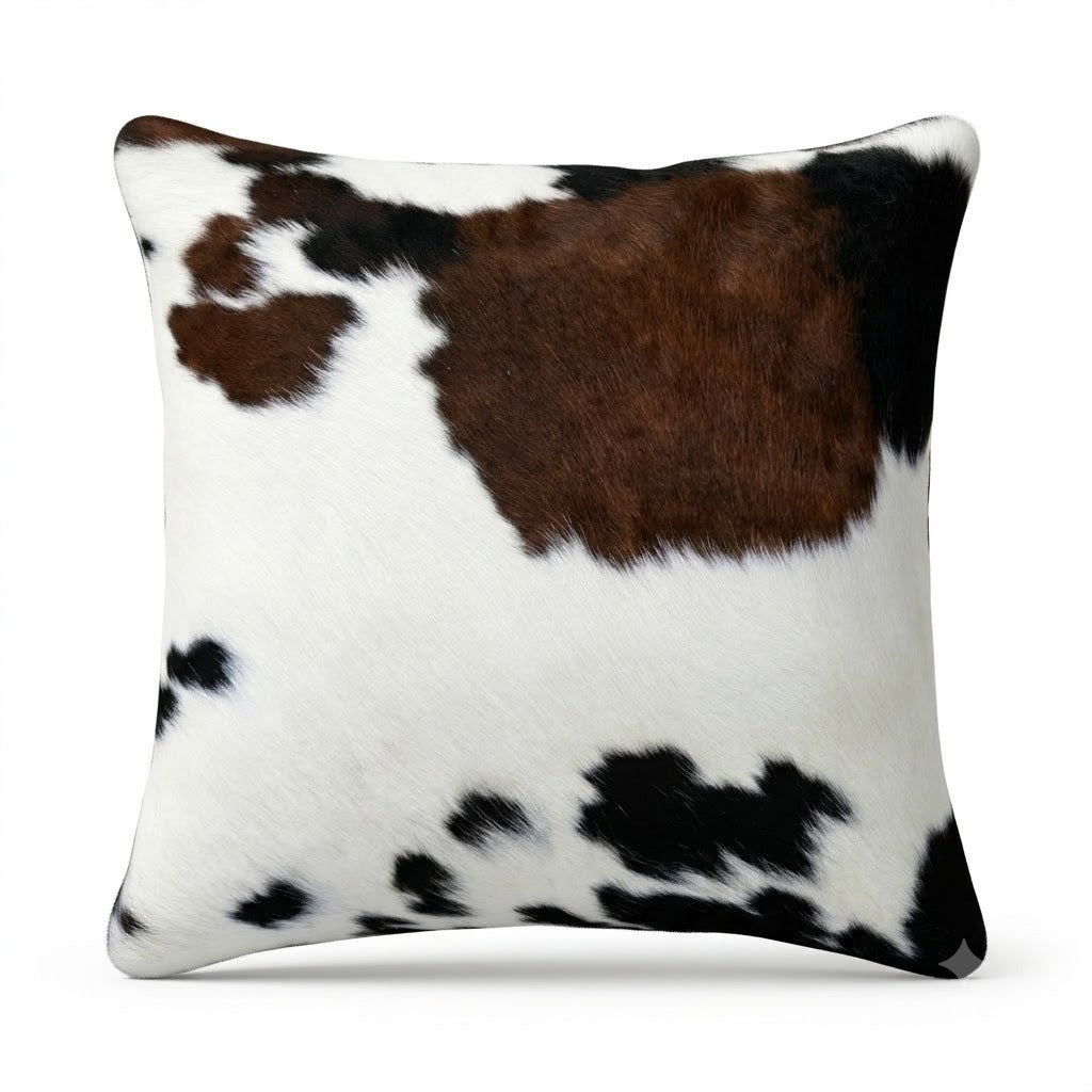 Cowhide cushion pillow with brown, black, and white pattern 