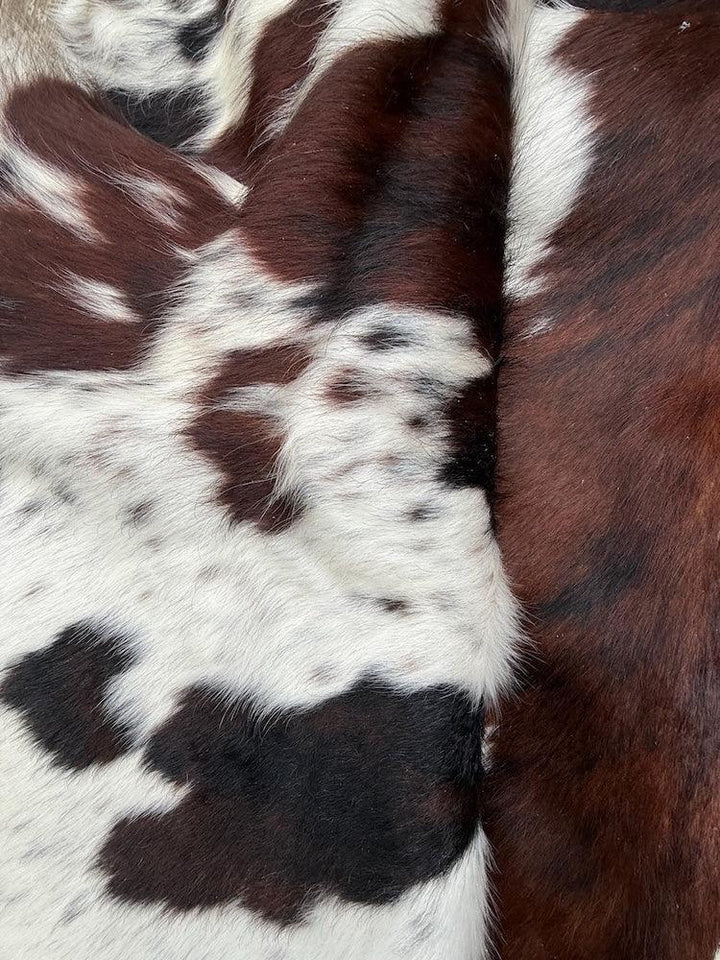 Premium cowhide rug from Cowhide Rugs London, 205cm x 180cm, natural cowhide with unique pattern and soft texture.
