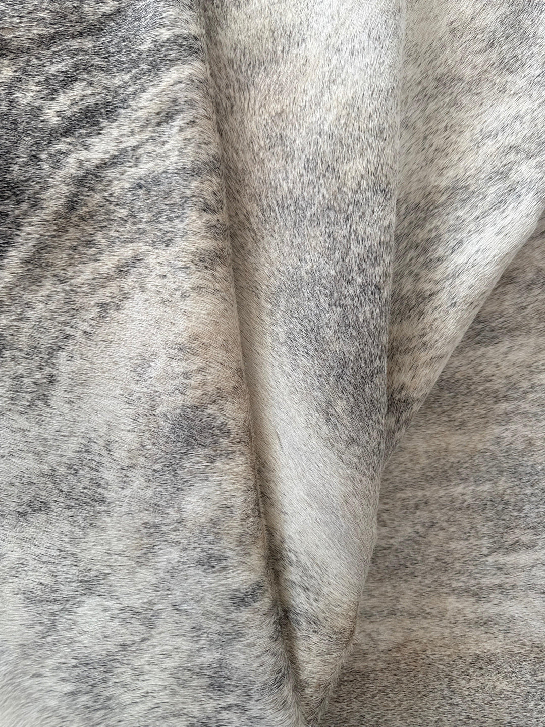 Premium Cowhide Rug by Cowhide Rugs London, natural cowhide with black and white patches, measuring 220cm by 210cm.
