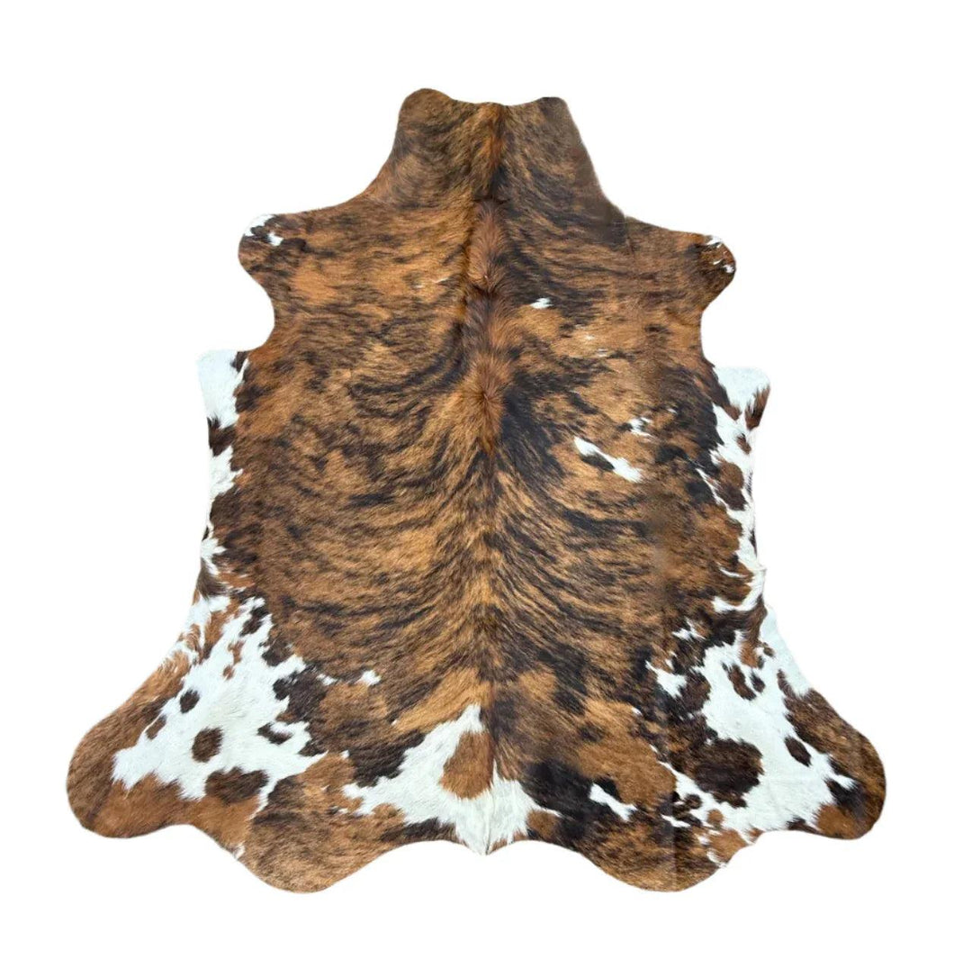 Premium cowhide rug by Cowhide Rugs London, 220cm x 195cm, natural cowhide with distinctive markings and soft texture.