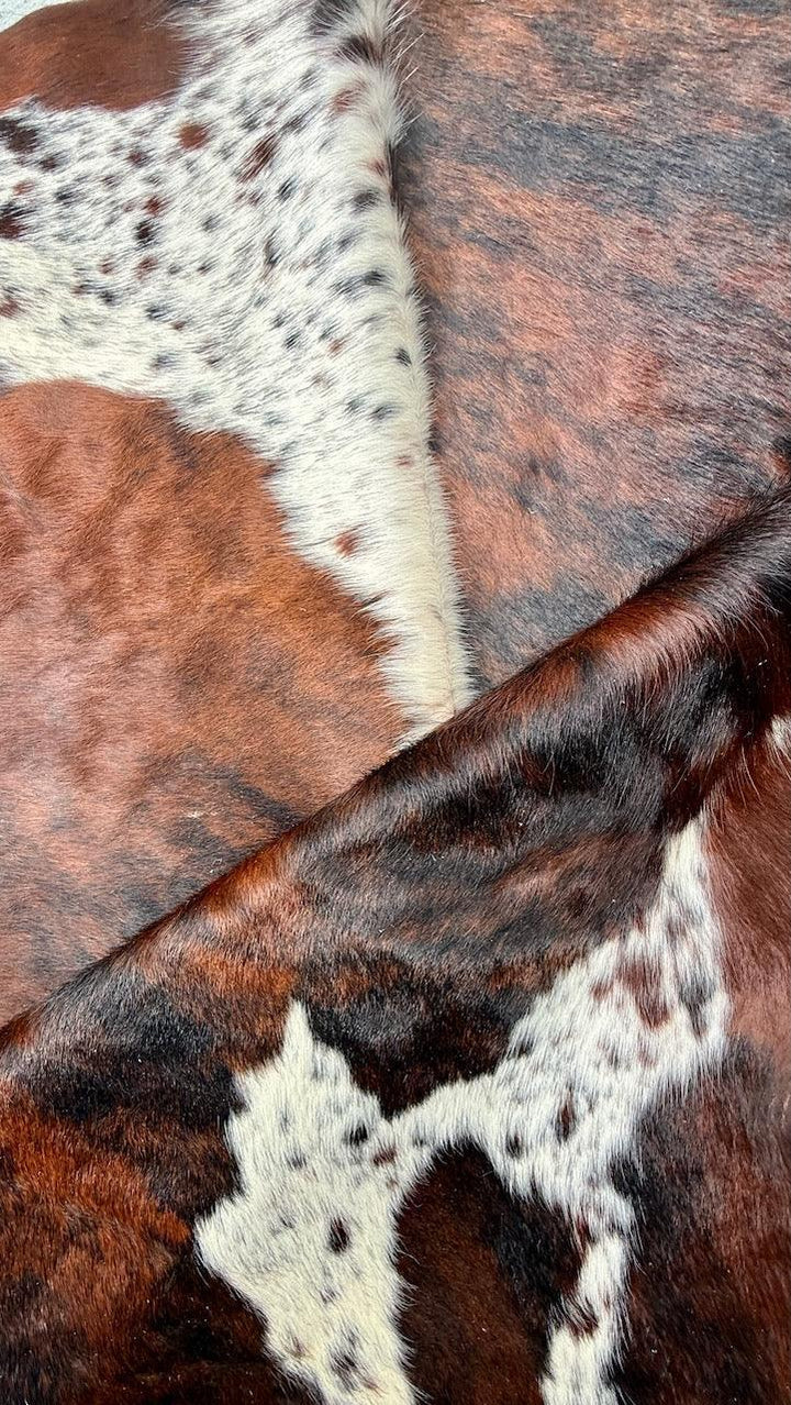 Premium Cowhide Rug by Cowhide Rugs London, large 235cm x 199cm natural cowhide with distinctive markings and smooth surface.