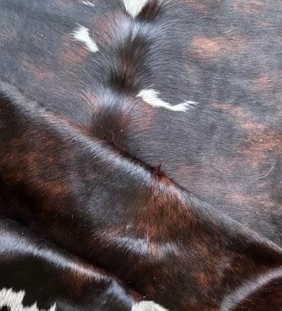 Large premium cowhide rug from Cowhide Rugs London, 220cm x 178cm, featuring natural cowhide pattern and soft texture.
