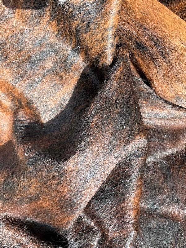 Premium cowhide rug by Cowhide Rugs London, showcasing natural cowhide pattern and texture in a large 243cm by 211cm size.