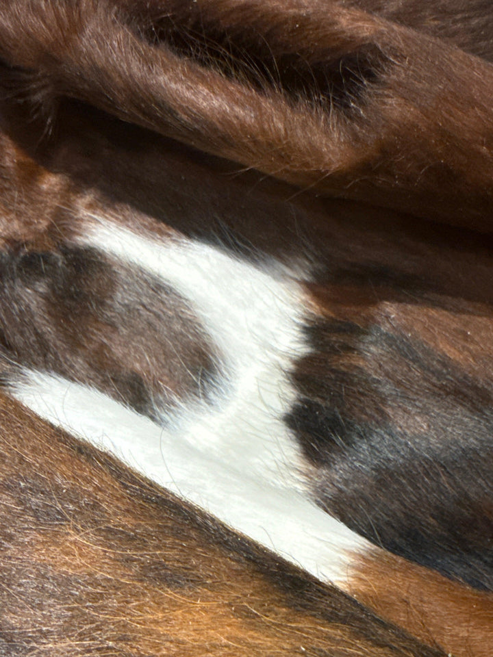 Premium cowhide rug by Cowhide Rugs London, XL size 200cm x 178cm, showcasing the natural cowhide pattern and texture.