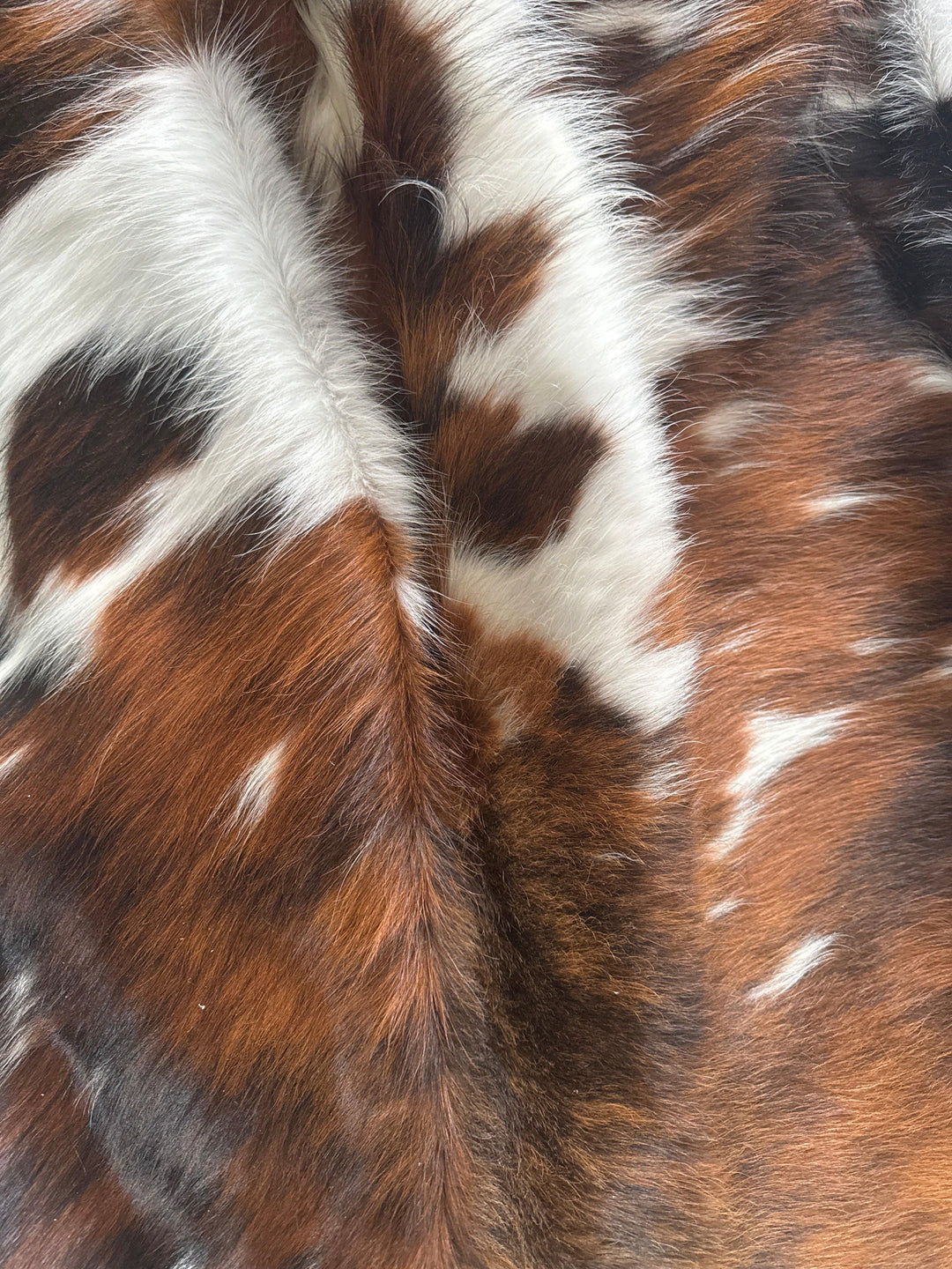 Premium Cowhide Rug from Cowhide Rugs London, large natural cowhide with a rich texture and distinctive markings.