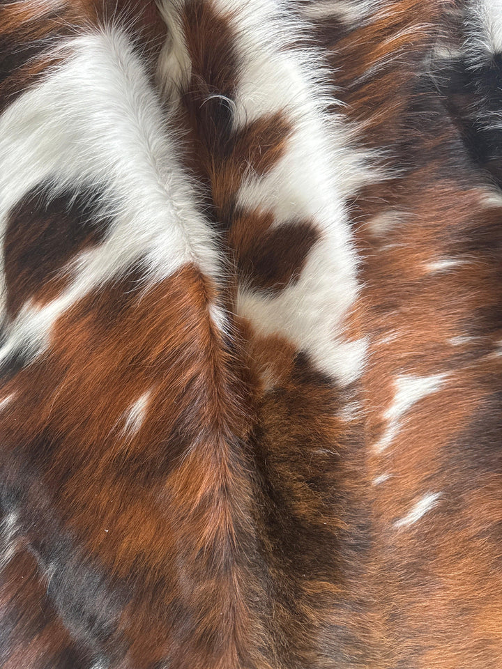 Premium Cowhide Rug from Cowhide Rugs London, large natural cowhide with a rich texture and distinctive markings.