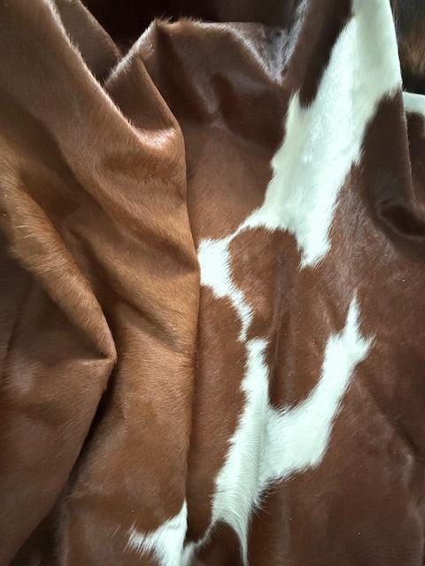 Premium cowhide rug by Cowhide Rugs London, natural cowhide pattern, 195cm x 185cm, over £200, with unique organic texture.
