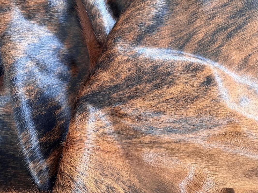 Premium cowhide rug from Cowhide Rugs London, XXL size 245cm x 225cm, natural cowhide with distinctive pattern and rich texture.