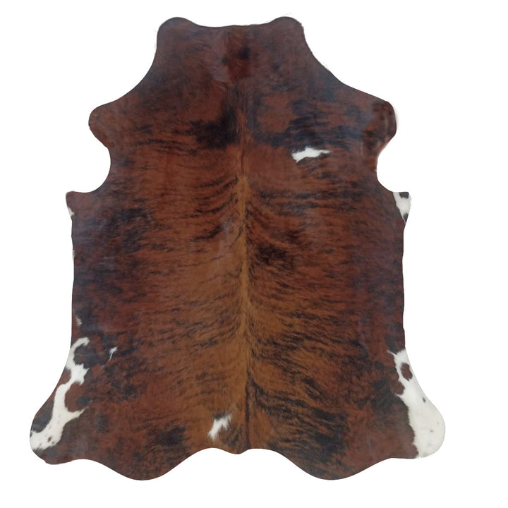 Brown and black cowhide rug with white spots