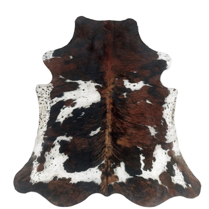 Natural cowhide rug in black and white, 230cm x 200cm, from Cowhide Rugs London, showcasing its textured, irregular pattern.