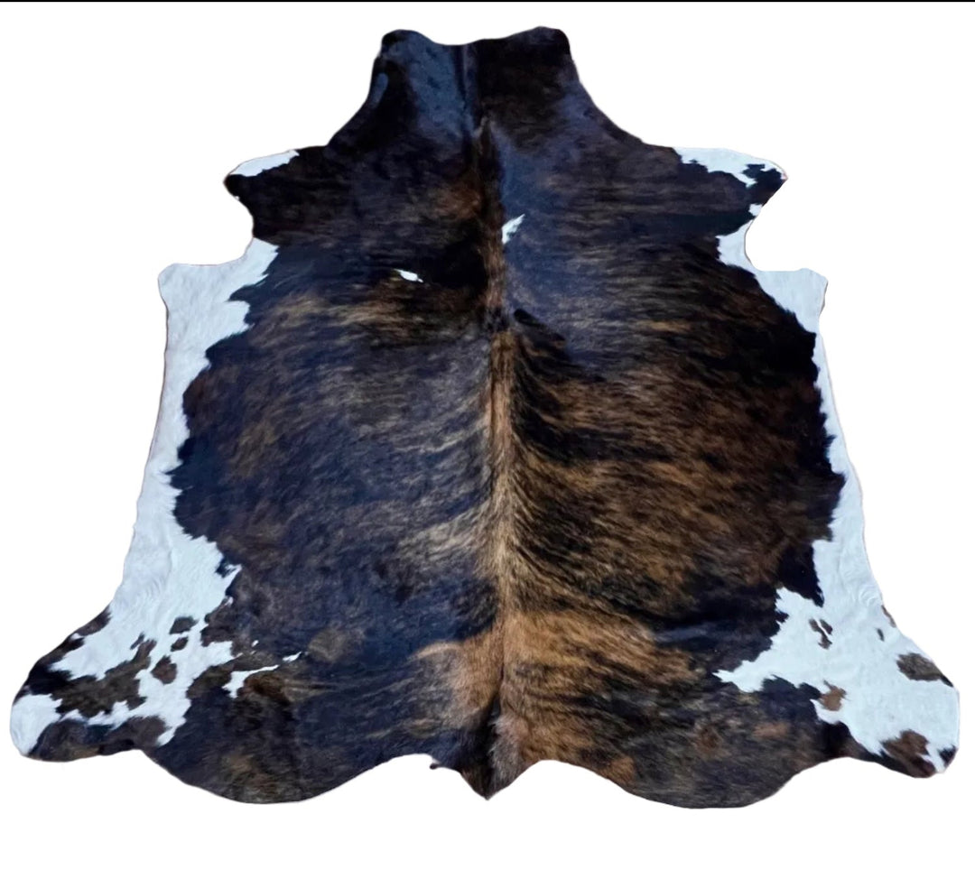 Large cowhide rug from Cowhide Rugs London, 223cm x 191cm, natural brown and white tones, soft and textured surface.