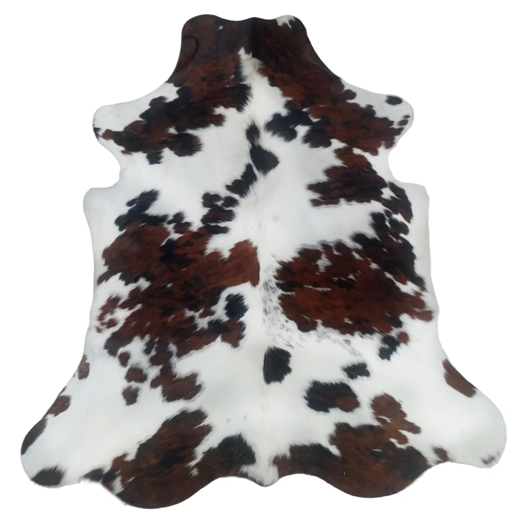 Cowhide rug with brown, black, and white pattern on a white background