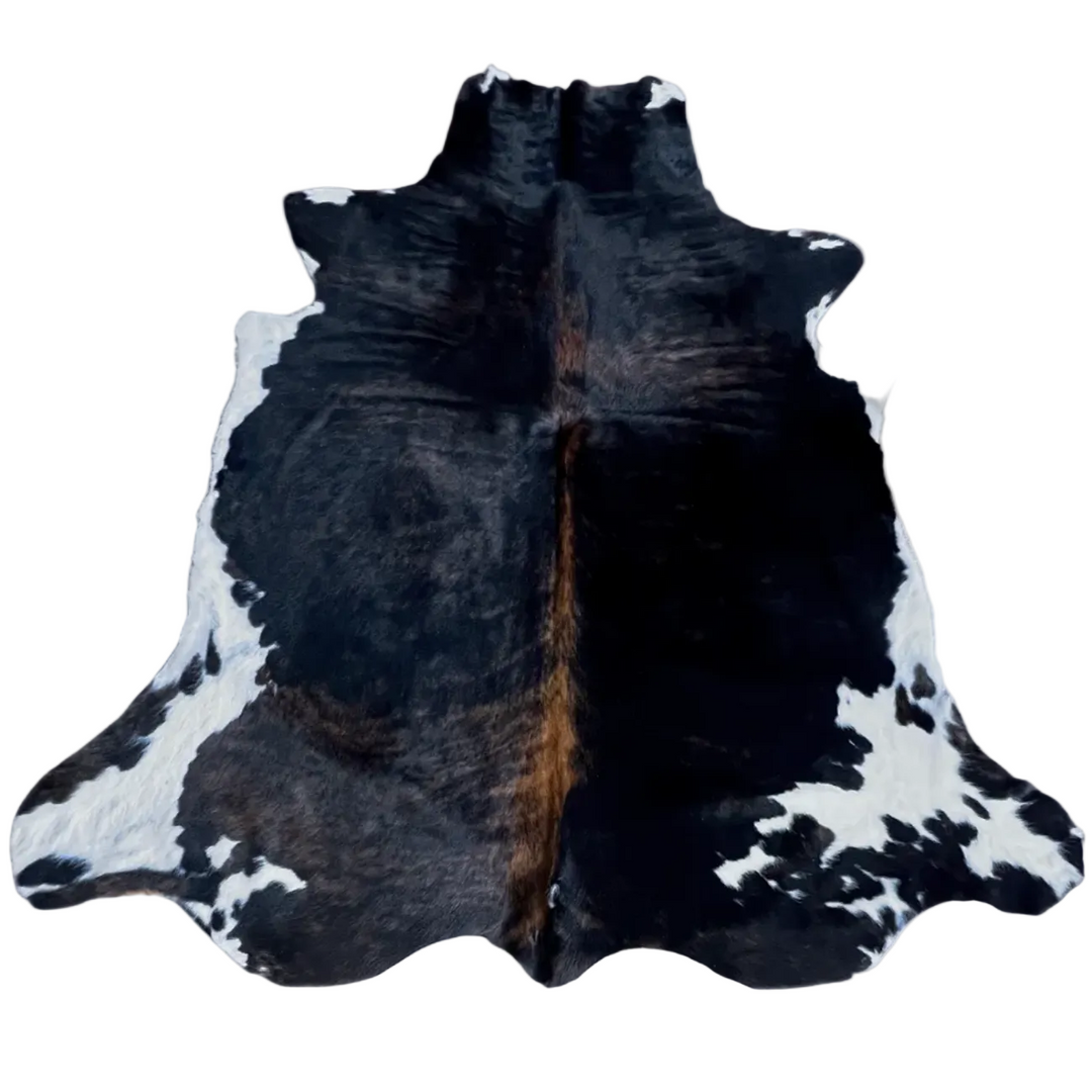 Large cowhide rug from Cowhide Rugs London, measuring 201cm x 189cm with natural brown and white patches on a smooth leather surface.