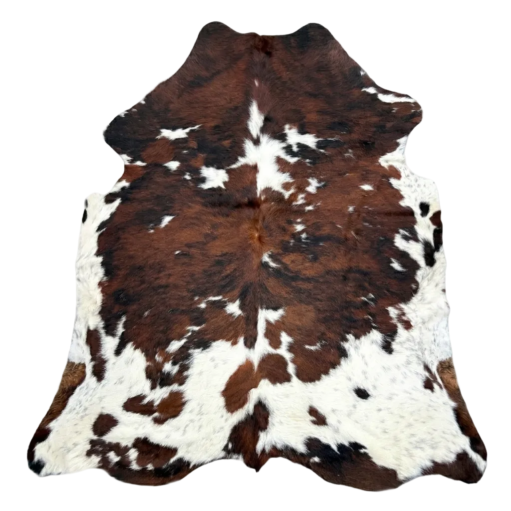 Brown and white cowhide rug on a light gray background